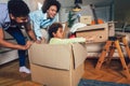 African American family, parents and daughter, unpacking boxes and moving into a new home Royalty Free Stock Photo