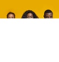 African american family peeking out blank white advertisement board Royalty Free Stock Photo