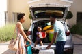 African american family smiling while standing near their car outdoors Royalty Free Stock Photo