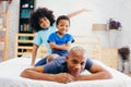 African American family of three, kids sitting on father`s back Royalty Free Stock Photo