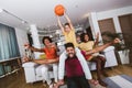 African American family of three watching tv and cheering basketball games on sofa at home