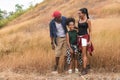 African american family travel together along trekking trail on mountain