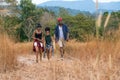 African american family travel together along trekking trail on mountain