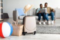 African American Family Using Laptop While Packed Suitcase Lying Indoor