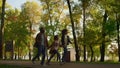 African american family walk autumn park together. Happy kid hold parents hands. Royalty Free Stock Photo