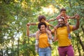 African American family walking trough park. Royalty Free Stock Photo