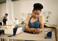 African american fashion designer cutting a piece of denim. Tailor working in her studio. Seamstress cutting a piece of Royalty Free Stock Photo