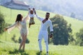 African American father with caucasian mother and mixed race baby spend time together. Happy mixed race family outdoor Royalty Free Stock Photo