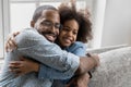 African american father cuddling little smiling biracial child daughter.