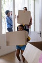 African american father and daughter carrying cardboard boxes while entering in new home Royalty Free Stock Photo