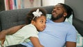 African american father and daughter lying on sofa sleeping at home Royalty Free Stock Photo