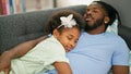 African american father and daughter lying on sofa sleeping at home Royalty Free Stock Photo