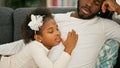 African american father and daughter lying on sofa sleeping at home Royalty Free Stock Photo