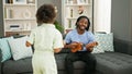 African american father and daughter playing ukulele dancing at home Royalty Free Stock Photo
