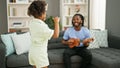 African american father and daughter playing ukulele dancing at home Royalty Free Stock Photo