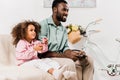 african american father and daughter playing video game in Royalty Free Stock Photo