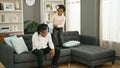 African american father and daughter sitting on sofa stressed for disturb at home