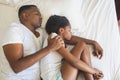 African American father and daughter sleeping together on bed in bedroom Royalty Free Stock Photo