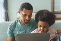 African American father and his cute son using laptop Royalty Free Stock Photo