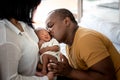 African American father kissing face, his 12-day-old baby black skin newborn Royalty Free Stock Photo