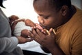 African American father kissing foot, his 12-day-old baby newborn Royalty Free Stock Photo