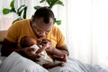 African American father kissing hand, his 12-day-old baby black skin newborn Royalty Free Stock Photo