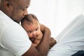 African American father kissing head his 3 months old baby newborn Royalty Free Stock Photo