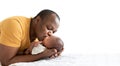 African American father kissing his 12-day-old baby black skin newborn son Royalty Free Stock Photo