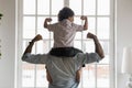African american father with little son on shoulders showing biceps. Royalty Free Stock Photo