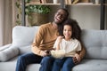 African American father and preschool daughter watching tv with popcorn Royalty Free Stock Photo