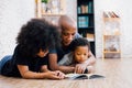 African American father reading a fairy tale fable story for kid