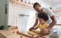 African American Father and son baking at home together. Child enjoying helping Dad. Brazilian family in the kitchen