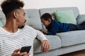 African american father and son using mobile phone while resting Royalty Free Stock Photo