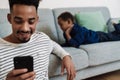 African american father and son using mobile phone while resting Royalty Free Stock Photo