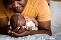 African American father used both hands to support his son`s head, 12-day-old baby black skin newborn son Royalty Free Stock Photo