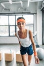 african american female athlete in headband and wristbands exercising