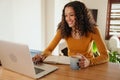 African American female business woman smiling working from home typing on laptop
