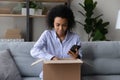 African American female buyer unpack box with order Royalty Free Stock Photo