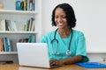 African american female doctor answering questions of patient online Royalty Free Stock Photo