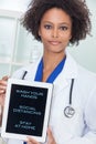 African American Female Doctor With Coronavirus Advice on Tablet Computer