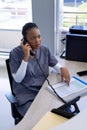 African american female doctor talking on phone in hospital reception Royalty Free Stock Photo