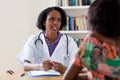 African american female doctor talking to patient Royalty Free Stock Photo