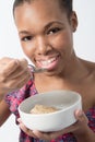 African American Female eating bowl of breakfast Royalty Free Stock Photo