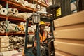 African American female forklift driver working in a textile warehouse Royalty Free Stock Photo