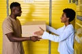 African American female gives her boyfriend cardboard box with things