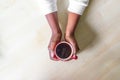 African American Female hands holding red cup of coffee espresso or cappuccino on on granite Kitchen counter-top. Black woman hand Royalty Free Stock Photo