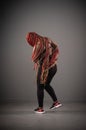 African American female joyfully dancing hip-hop against a gray background Royalty Free Stock Photo