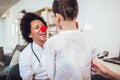 African American female pediatrician with stethoscope and clown nose talking to boy Royalty Free Stock Photo