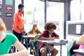 African american female teacher and diverse pupils at work in classroom