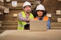 African American Female worker and colleague inspect paper storage warehouse